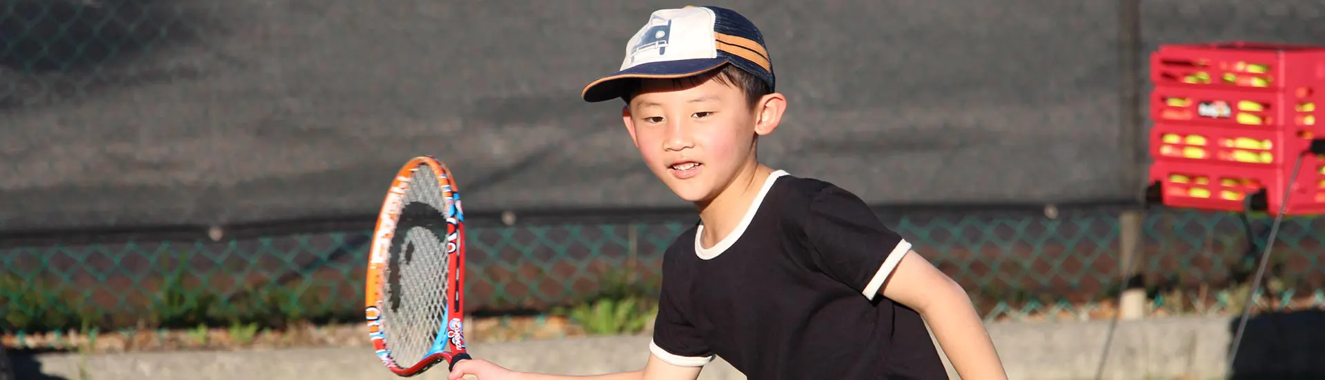 Young boy playing tennis forehand in Red Hot Shots lesson 