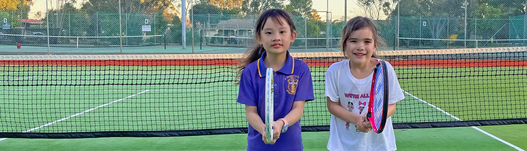 Two young tennis players having fun