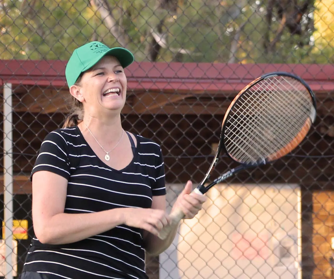 Laughing adult tennis player