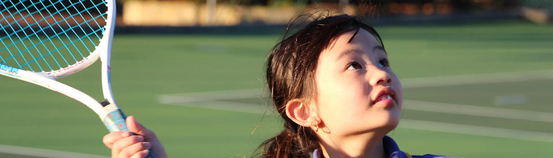 Young tennis player about to serve